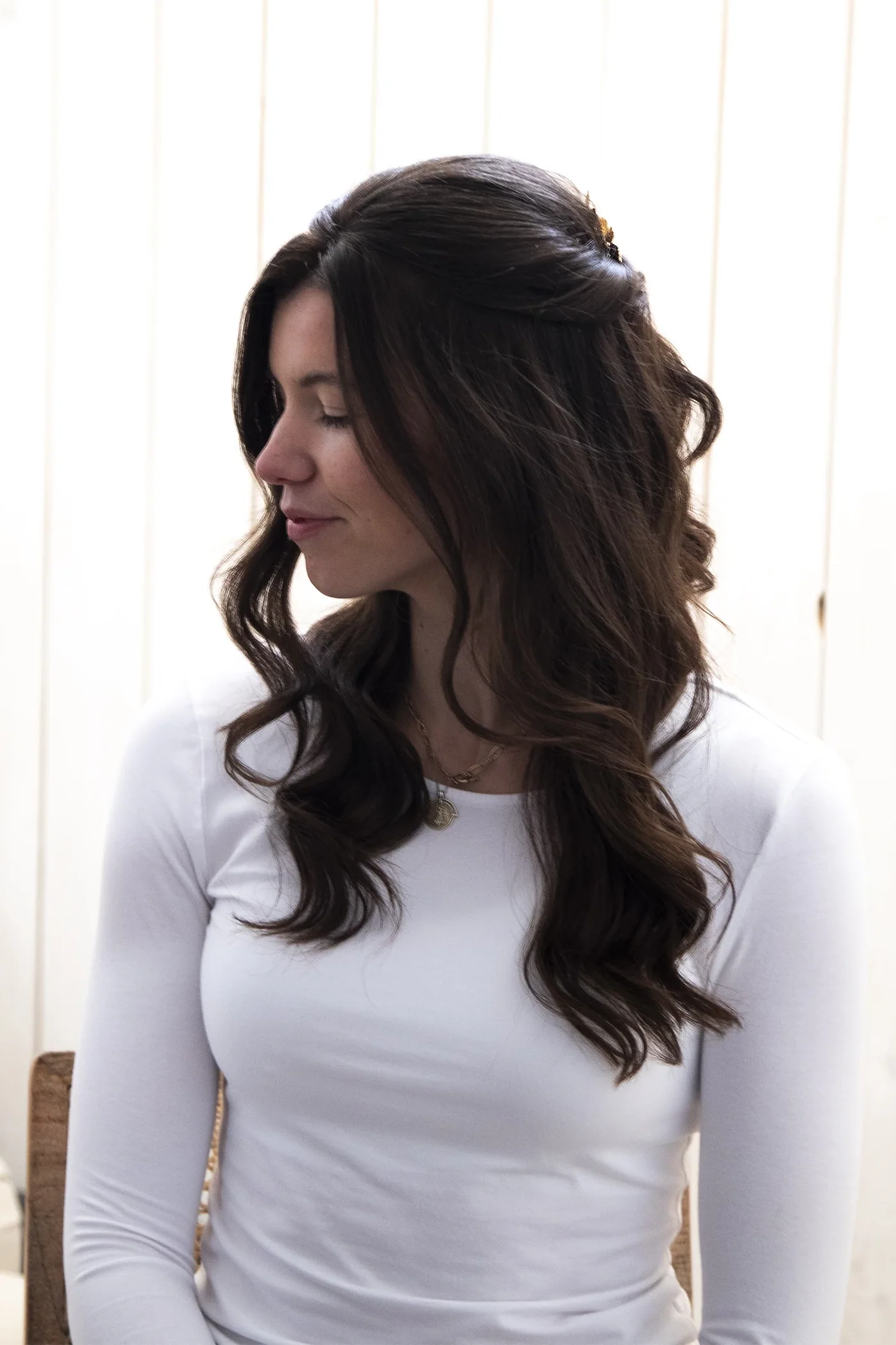 Half-up bridal hairstyle with loose, soft curls for a Cotswold bride