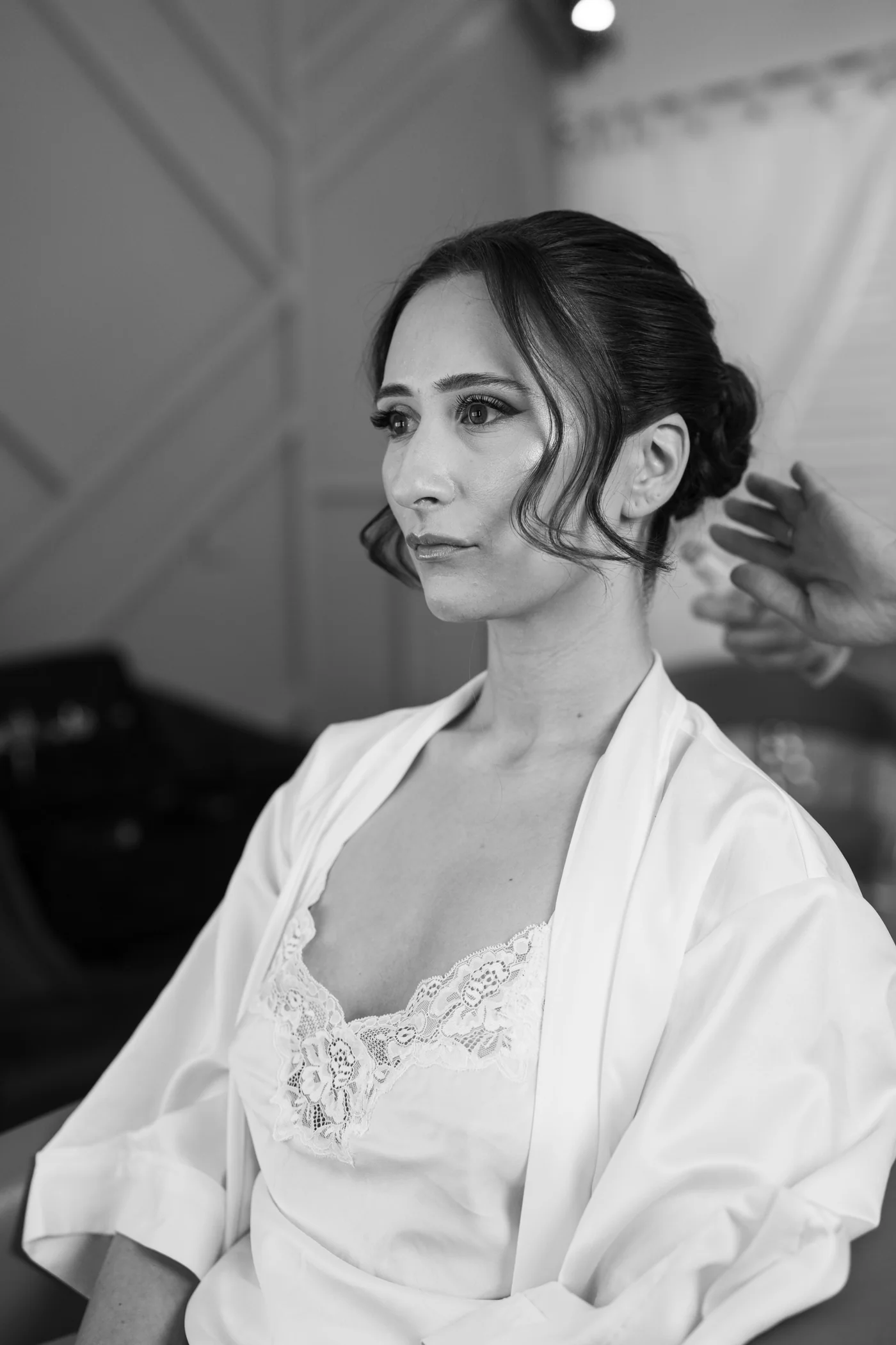 Sleek low bun with face-framing waves — Photography by Gemma Pimm